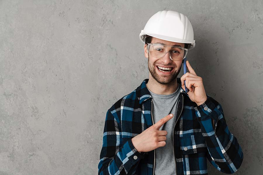 A contractor who is really happy his phone is ringing with a new hot prospective lead.